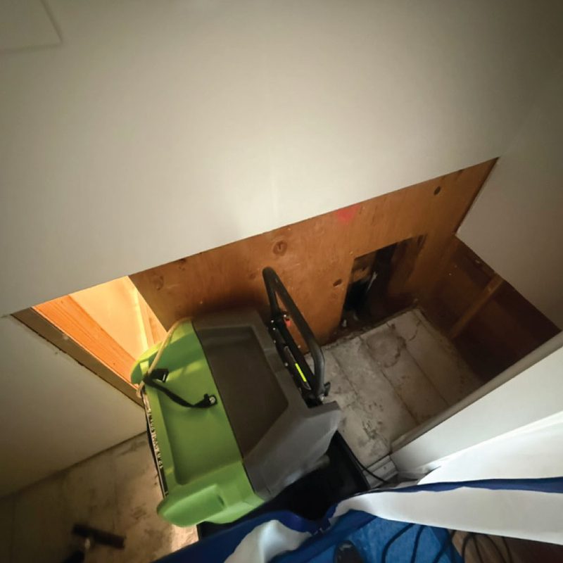 Damaged drywall removed and a commercial dehumidifier running during structural drying